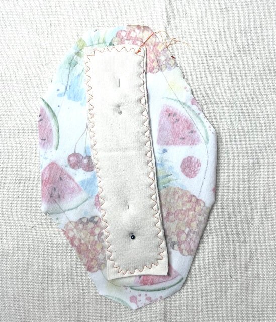 How to sew comfortable sanitary pad Attaching the absorbent layer to the top piece with zig zag stitch.