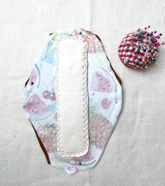 How to sew comfortable sanitary pad Pinning top and back pieces together with right sides facing each other.