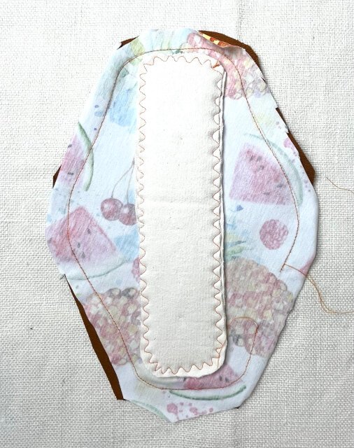 How to sew comfortable sanitary pad Sewing the back and top pieces together with a straight stitch.