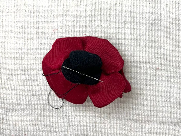 Attaching the pistil to Remembrance Day poppy