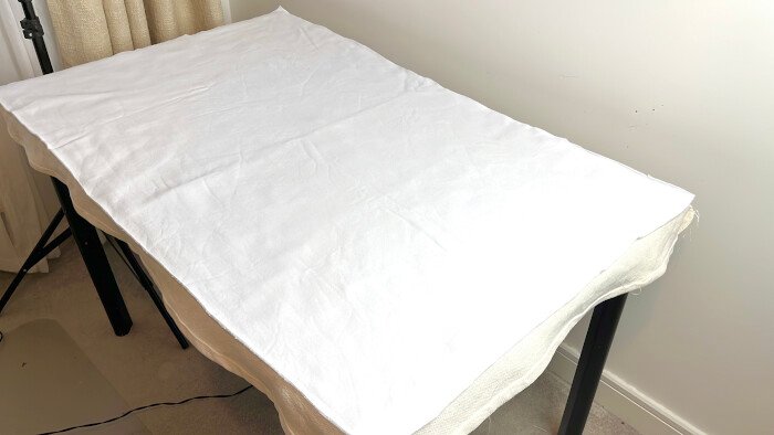 Adding backing to the table cover for photography backdrop.