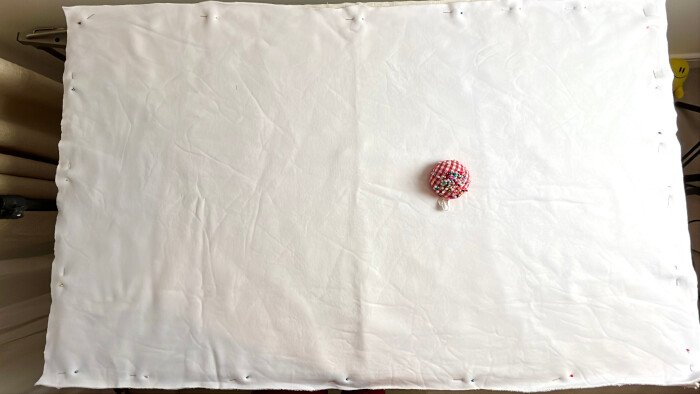 Pinning the backing to the table cover.
