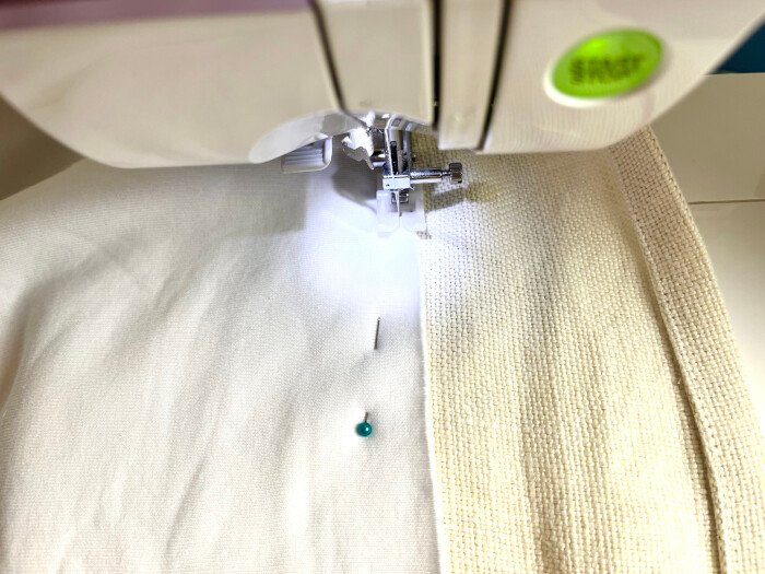 Sewing the backing to the table cover with long stitch.
