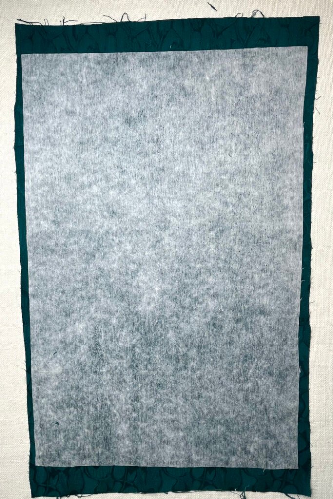 Backing fabric and interfacing layered together before sewing the advent calendar base panel.