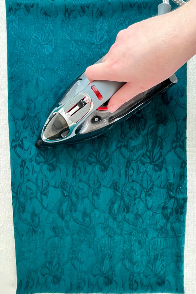 Turned and pressed base panel for a fabric advent calendar, ready for topstitching. Clean, minimalist foundation for attaching pockets.