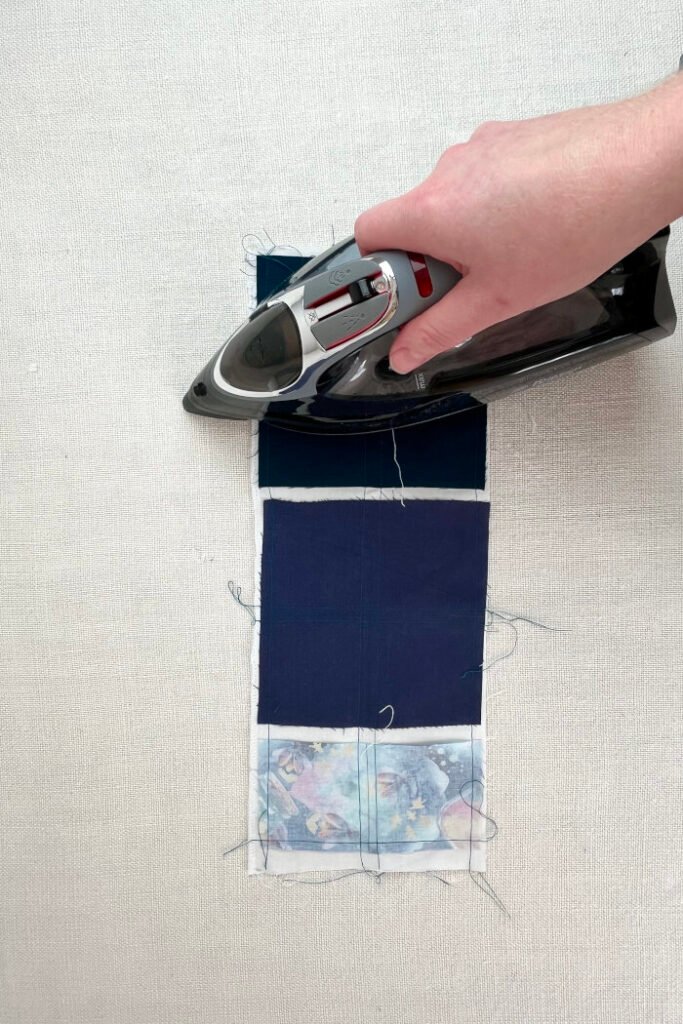 Pressing the sewn pockets squares to blend the stitching.