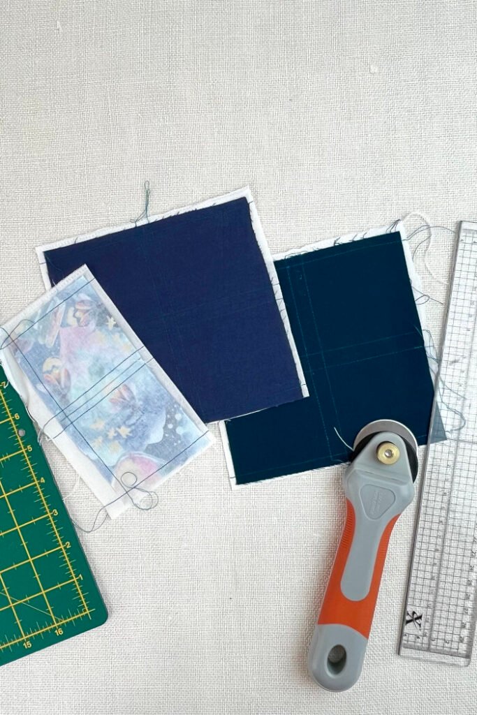 Cut fabric pieces for advent calendar pockets in 3x3 inch squares, ready to turn.  