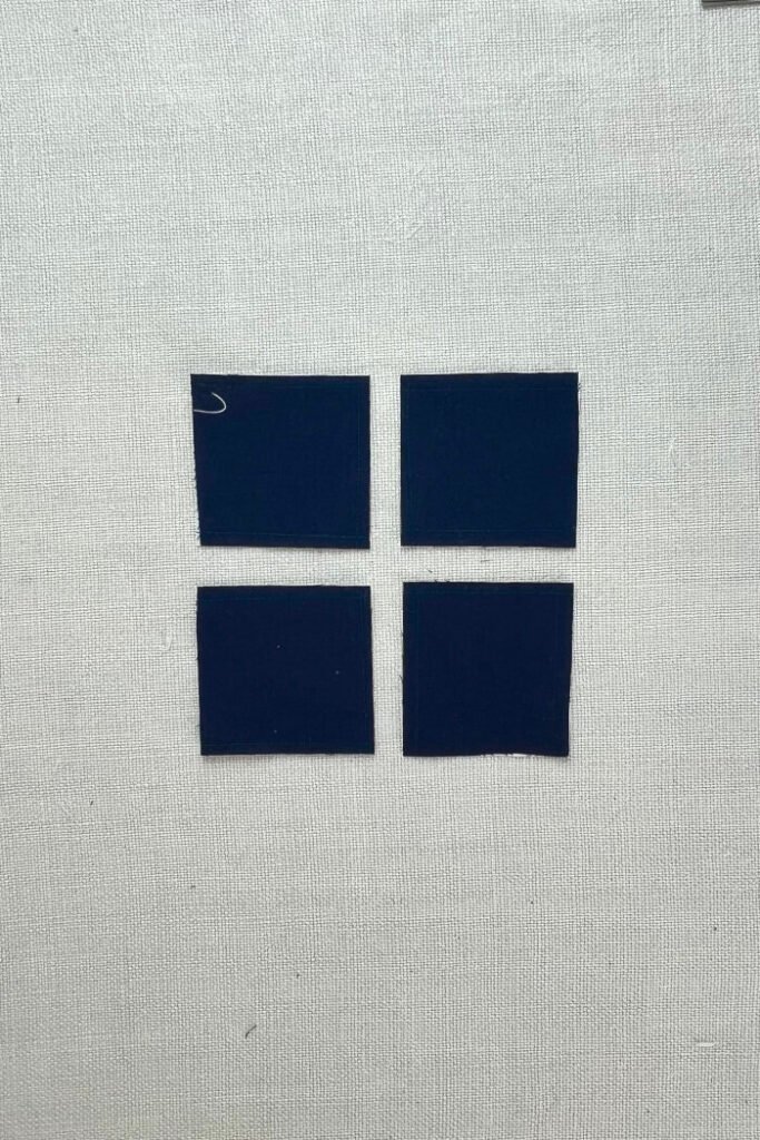 Cutting the larger pocket squares into 3" x 3" squares after sewing.