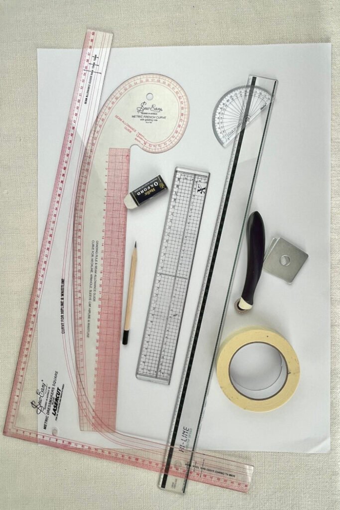 Pattern-drafting tools for creating a custom bodice block: pattern paper, ruler, French curve, and measuring tape.