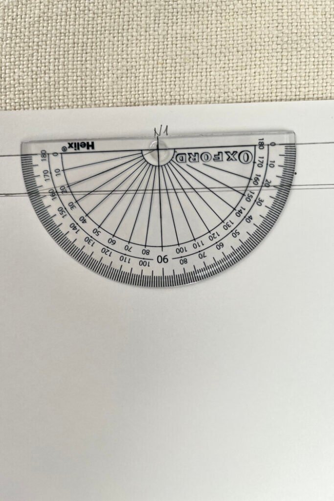 Using protractor to draft back shoulder slope.