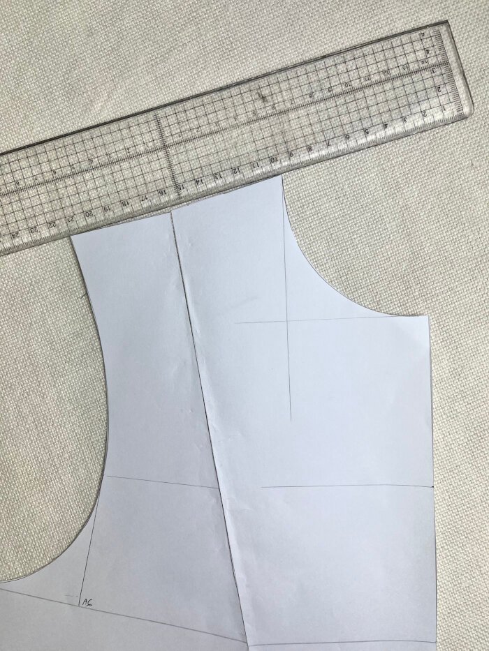 Checking the shoulder line on the bodice block by closing the dart and aligning the shoulder seam with a ruler.