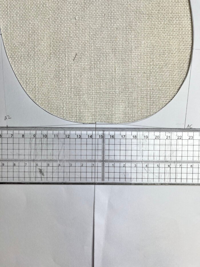 Matching the front and back armhole at the shoulder to assess curve continuity and correct sharp angles.