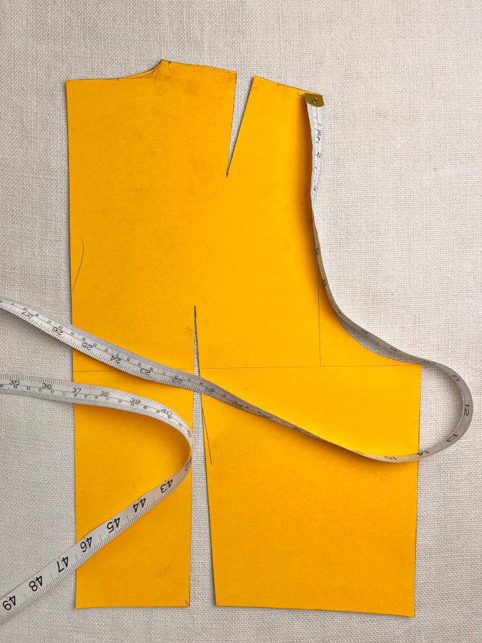 Demonstrating how to measure the armscye length on a bodice block for accurate sleeve drafting.