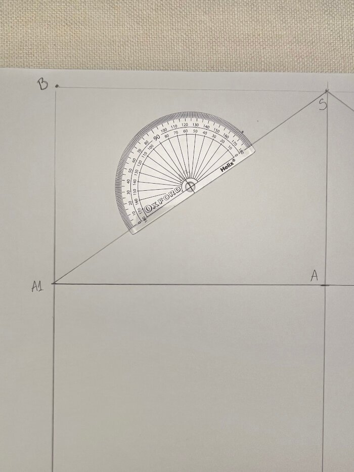 Using a protractor to create sleeve crown angles for accurate sleeve pattern drafting.