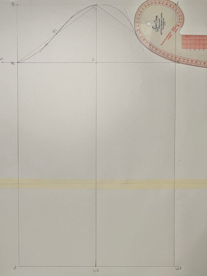 Shaping the front sleeve armhole curve using measured angles and curved rulers.