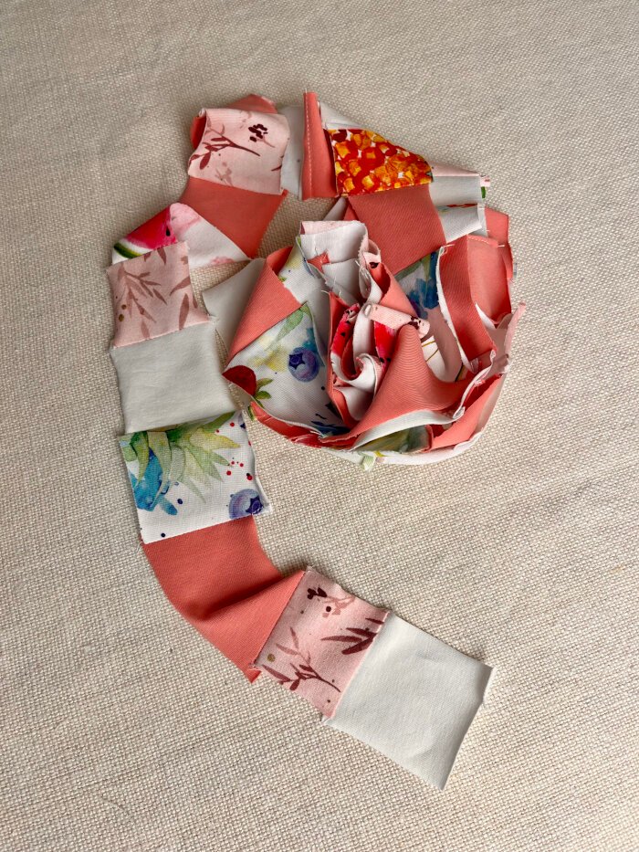 Patchwork fabric scrap chains prepared for a heart shaped coaster