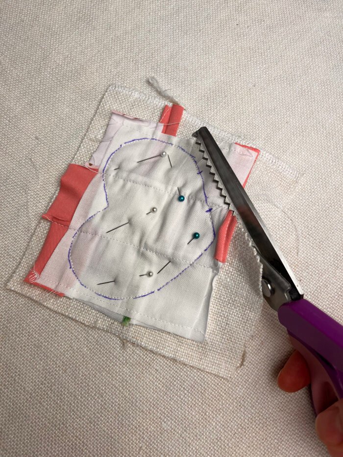 Trimming seam allowances on a heart shaped fabric coaster