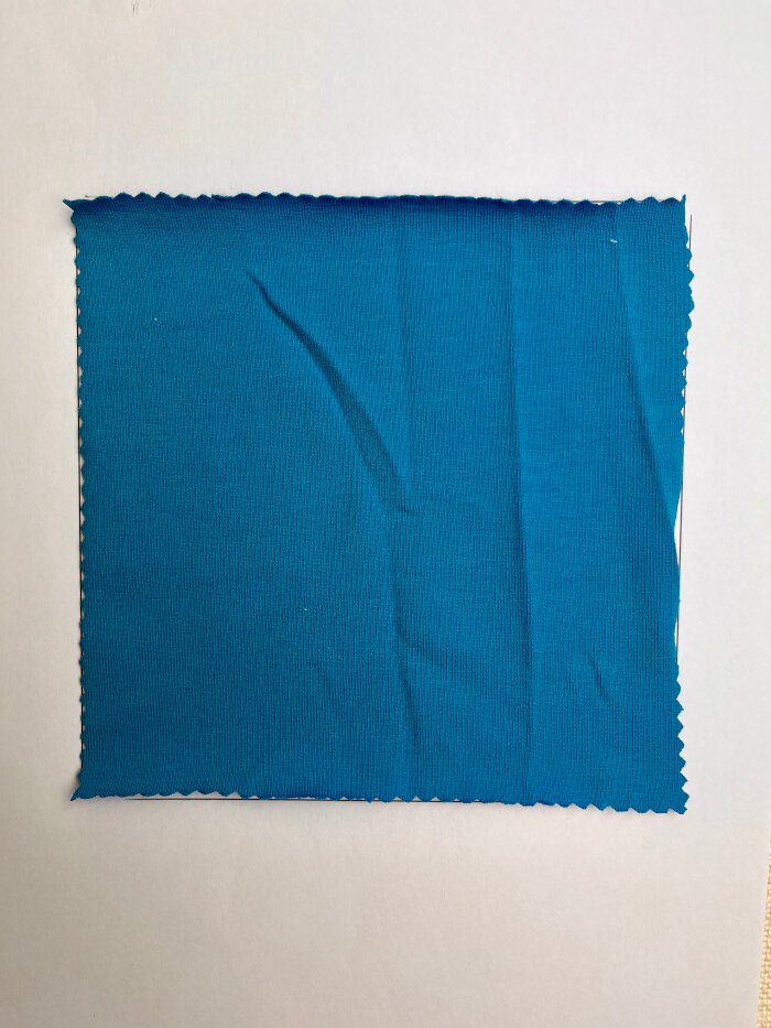 Cotton jersey fabric with rolled edges after washing