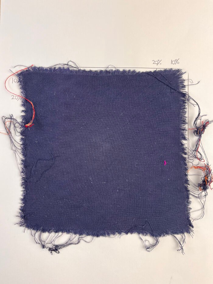 Woven rayon fabric after preshrinking showing frayed edges.