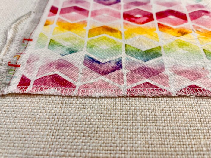 Overlocking raw fabric edges before washing natural fibres