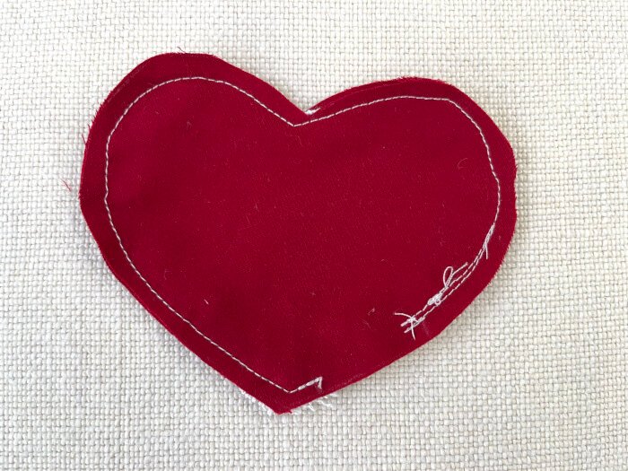 Sewn heart shaped brooch with a small opening for turning and stuffing