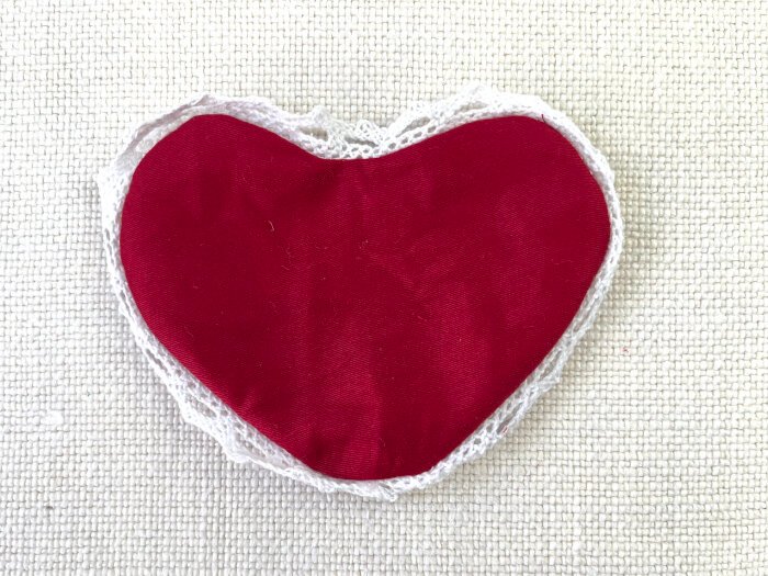 Turning the sewn heart shaped fabric brooch right side out through the opening