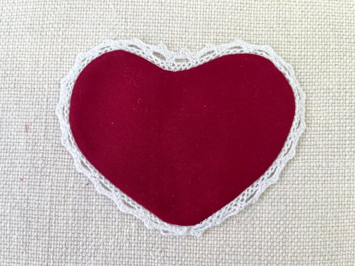 Pressed heart shaped brooch with smooth seams and shaped lace trim