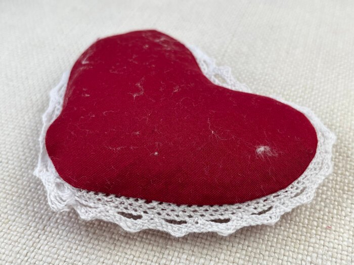 Filled heart brooch with lint on top before defluffing.