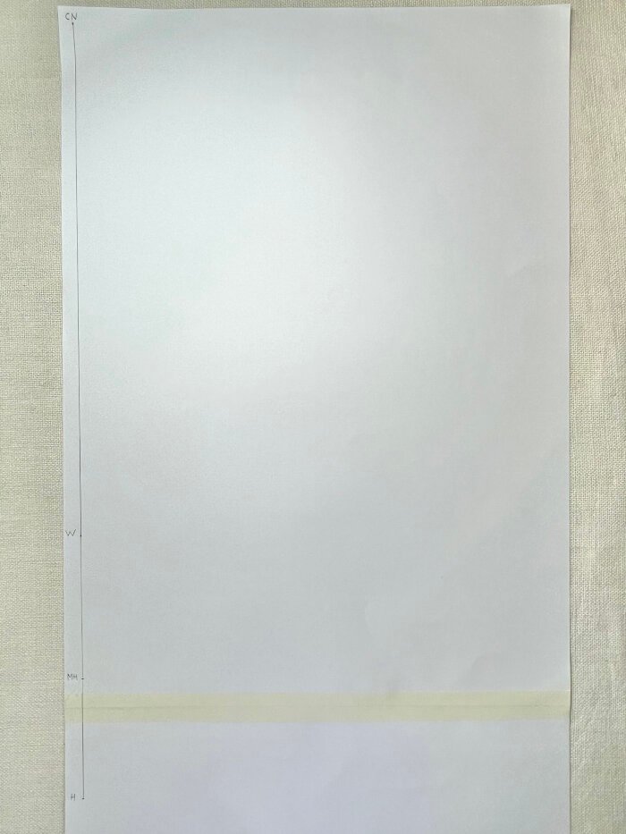 Marking vertical measurement on a T-shirt bodice block for mid hip and hip.