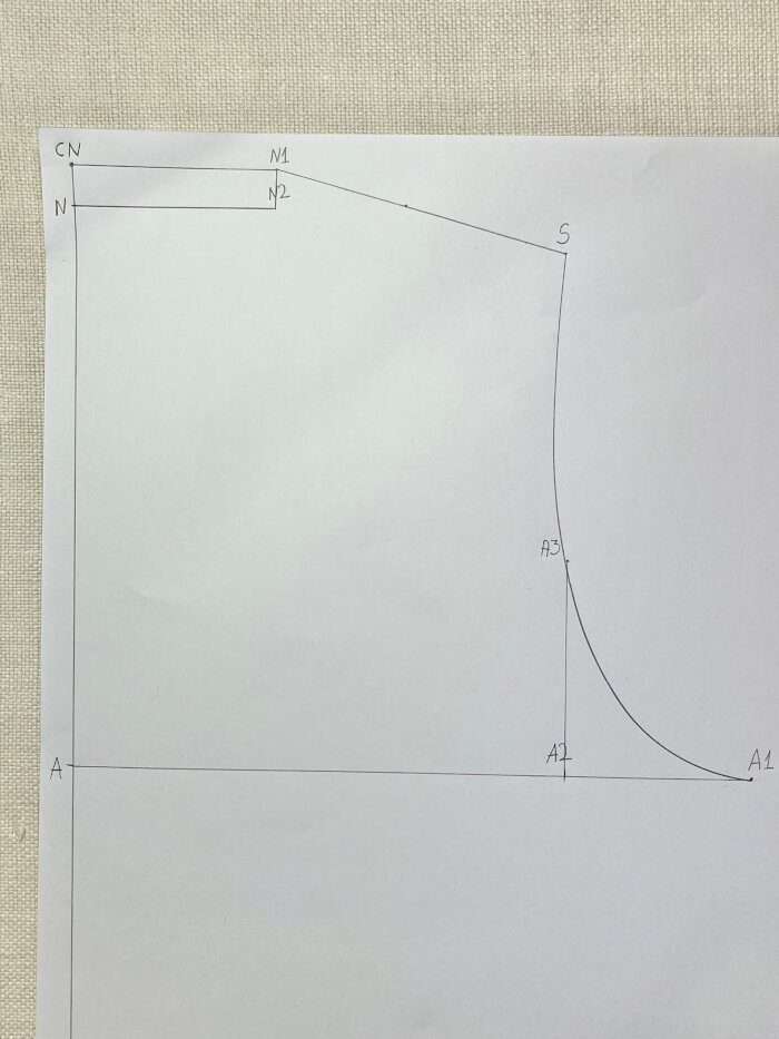 Drafting the armhole curve on a T-shirt pattern using a French curve