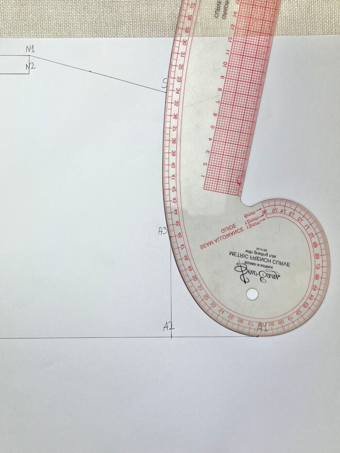 Drafting the armhole curve on a T-shirt pattern using a French curve