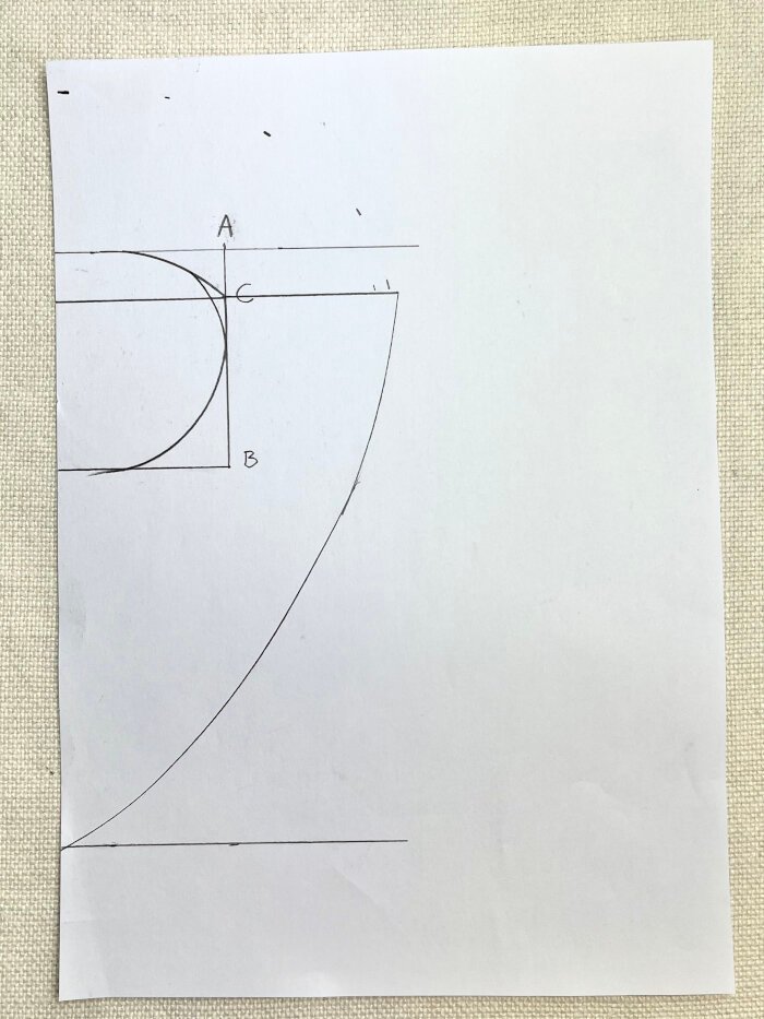 Marking shoulder width and back coverage on baby drool bib paper pattern