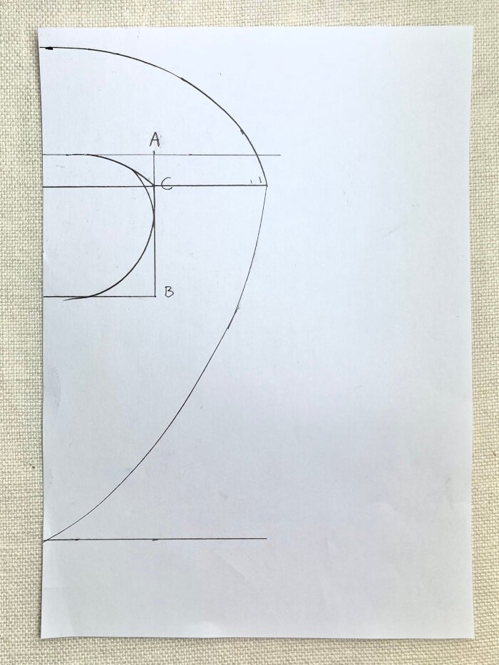 Connecting back neckline and shoulder points to form baby drool bib shape