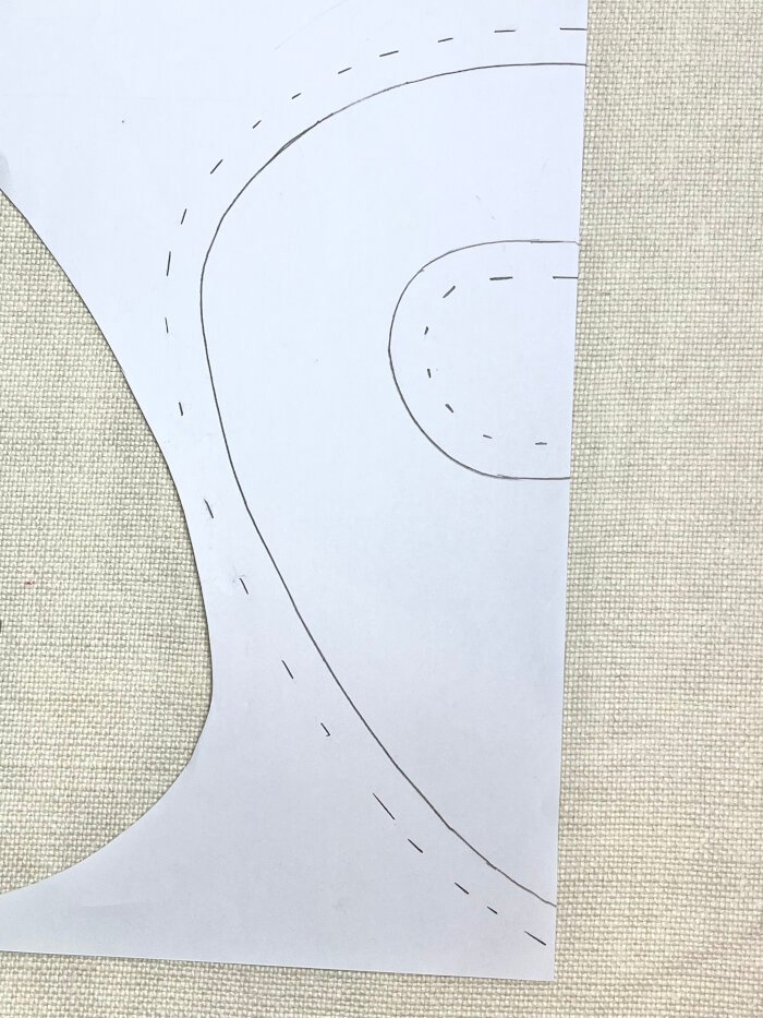 Adding one centimetre seam allowance around baby drool bib pattern edges