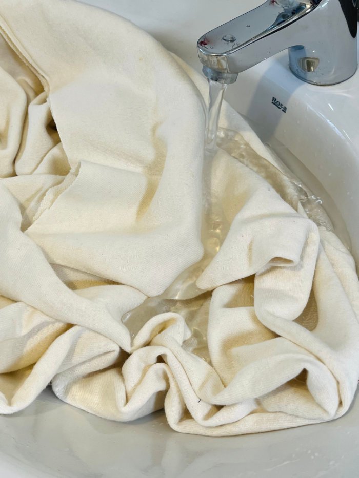 Hemp fabric soaked with water in sink before dyeing