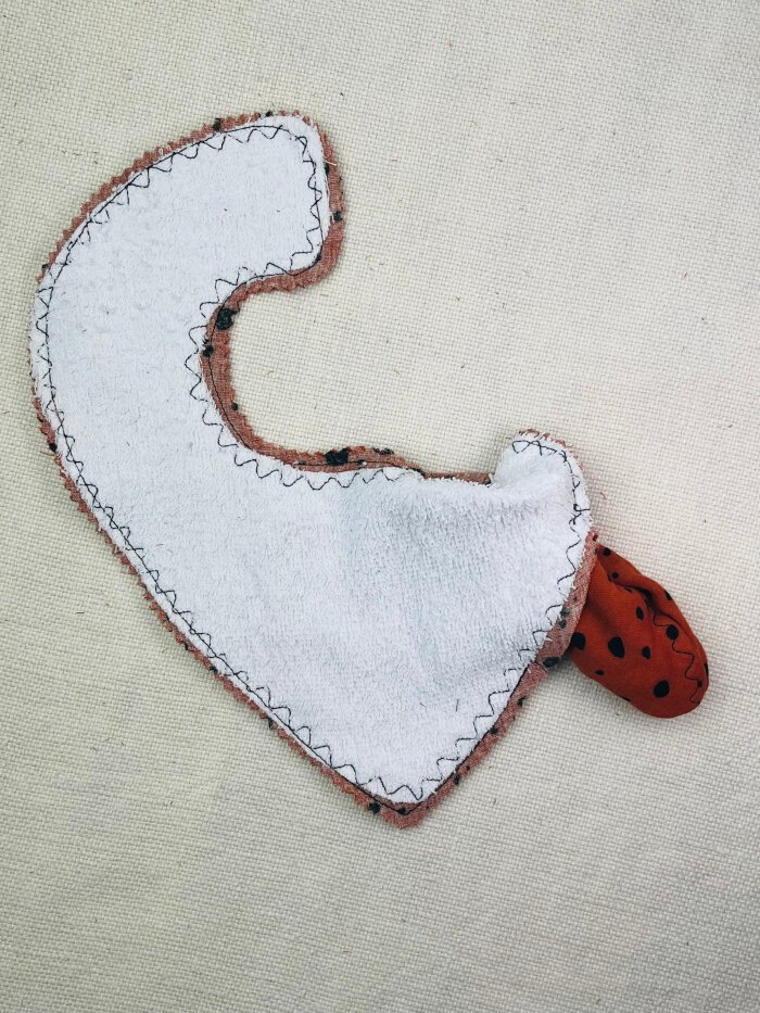 How to Sew a Baby Drool Bib (Easy Step-by-Step Sewing Tutorial) Turning a baby drool bib right side out through the opening