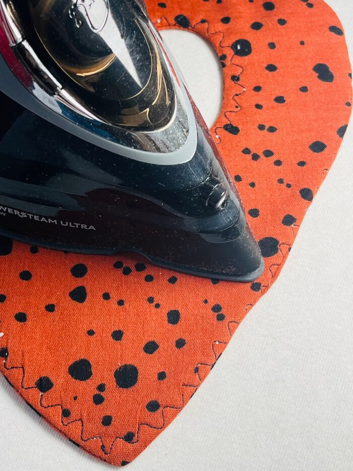 How to Sew a Baby Drool Bib (Easy Step-by-Step Sewing Tutorial) Pressing baby drool bib after turning, to smooth curved edges