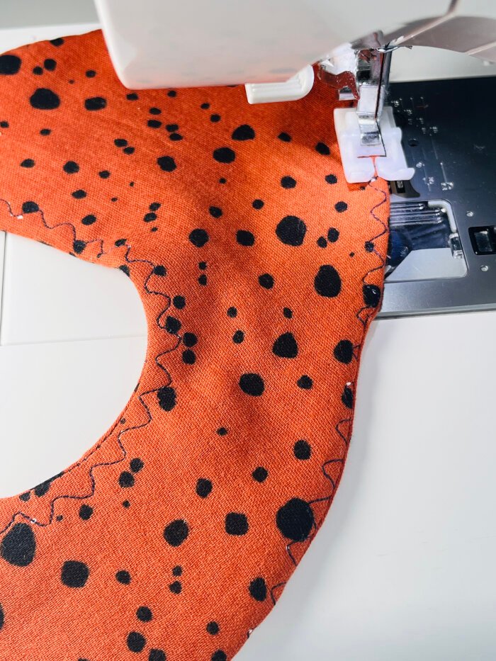 How to Sew a Baby Drool Bib (Easy Step-by-Step Sewing Tutorial) Topstitching around the edge of a baby drool bib to close turning hole