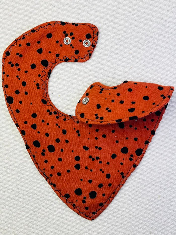 How to Sew a Baby Drool Bib (Easy Step-by-Step Sewing Tutorial) Completed baby drool bib showing snap closure placement at the neck