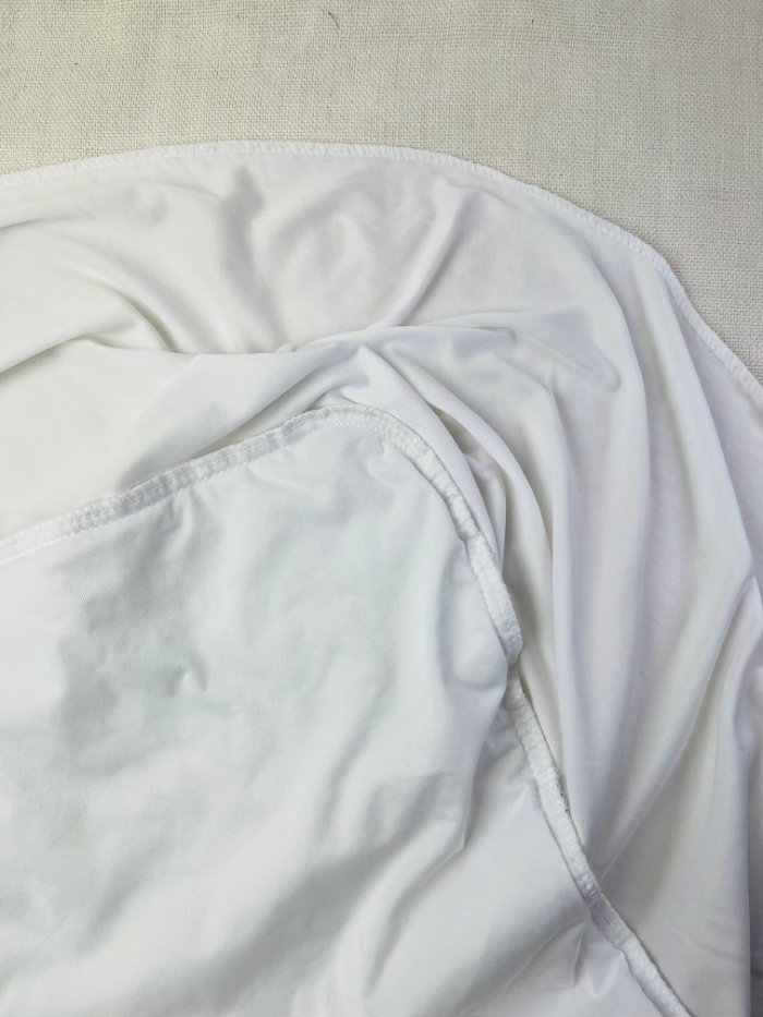 How to Fix Loose Elastic on a Waterproof Mattress Protector (Easy DIY Repair) Waterproof mattress protector with loose elastic slipping off mattress corner