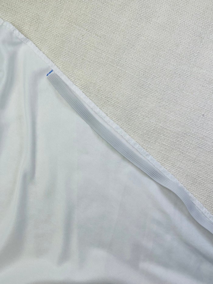 How to Fix Loose Elastic on a Waterproof Mattress Protector (Easy DIY Repair) Placing elastic between marked points on mattress protector corner