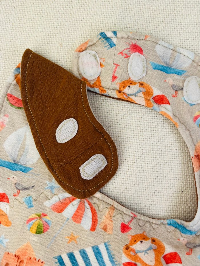 How to Sew a Baby Drool Bib (Easy Step-by-Step Sewing Tutorial) Example of Hook and Loop tape attached to a baby bib