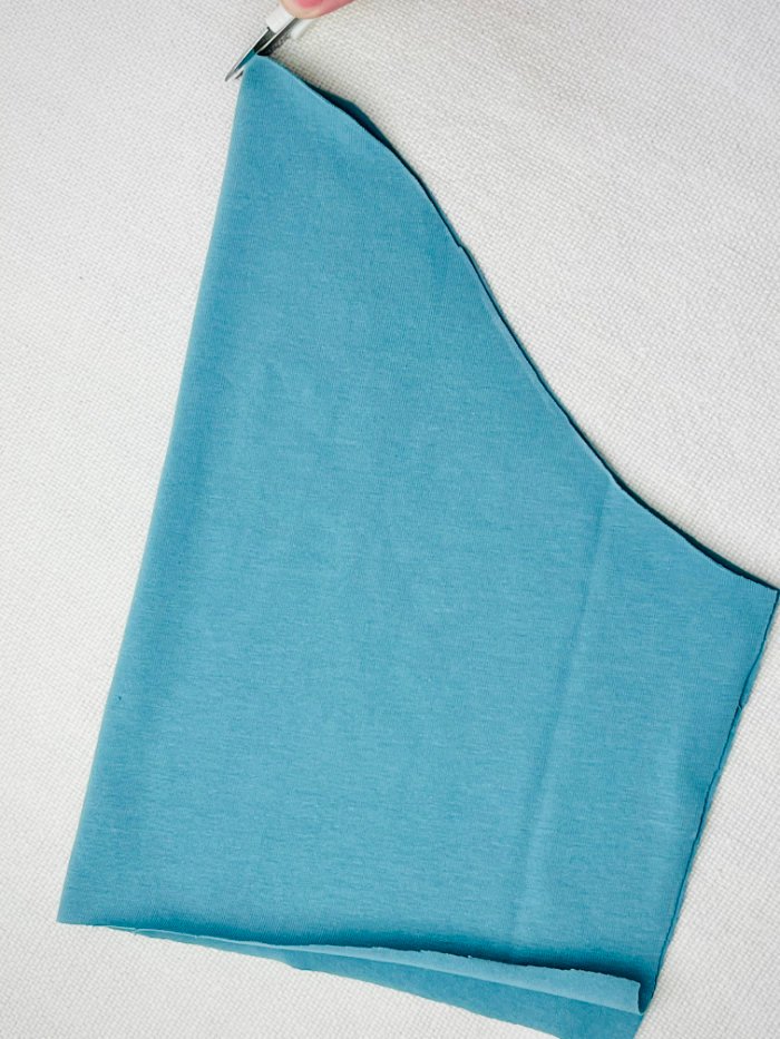 Marking notches on T-shirt pattern pieces for accurate sewing alignment