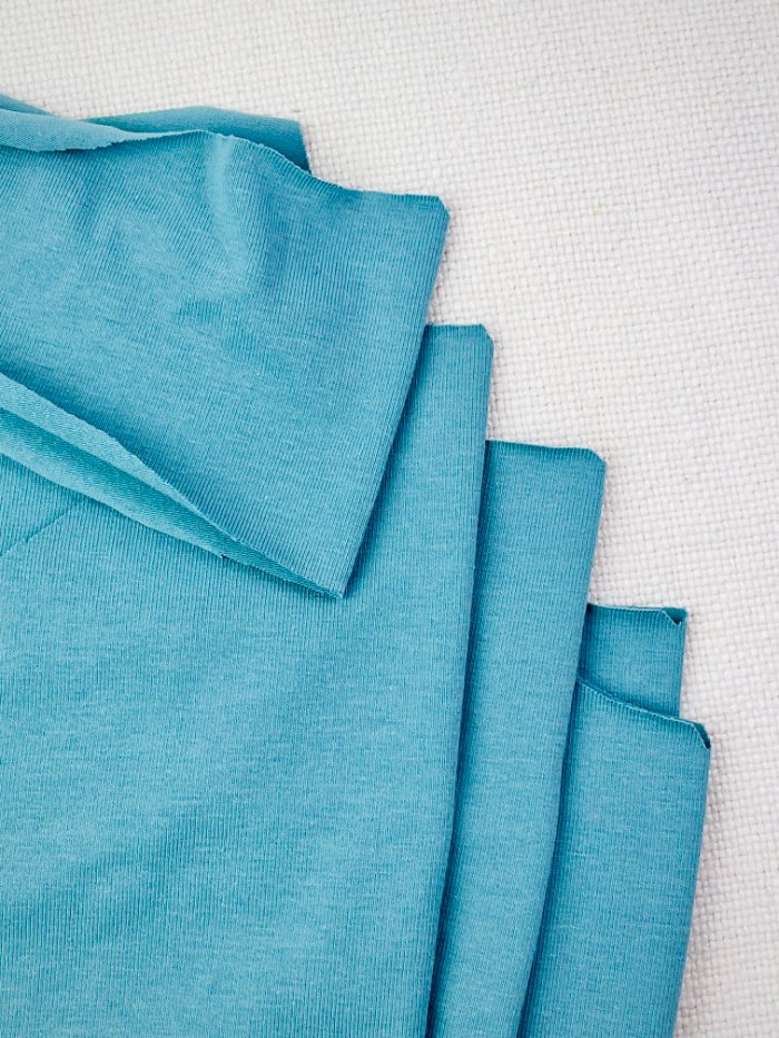 Marking notches on T-shirt pattern pieces for accurate sewing alignment