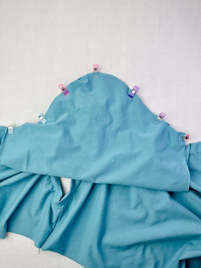 Pinning the knit T-shirt sleeve to the bodice before sewing