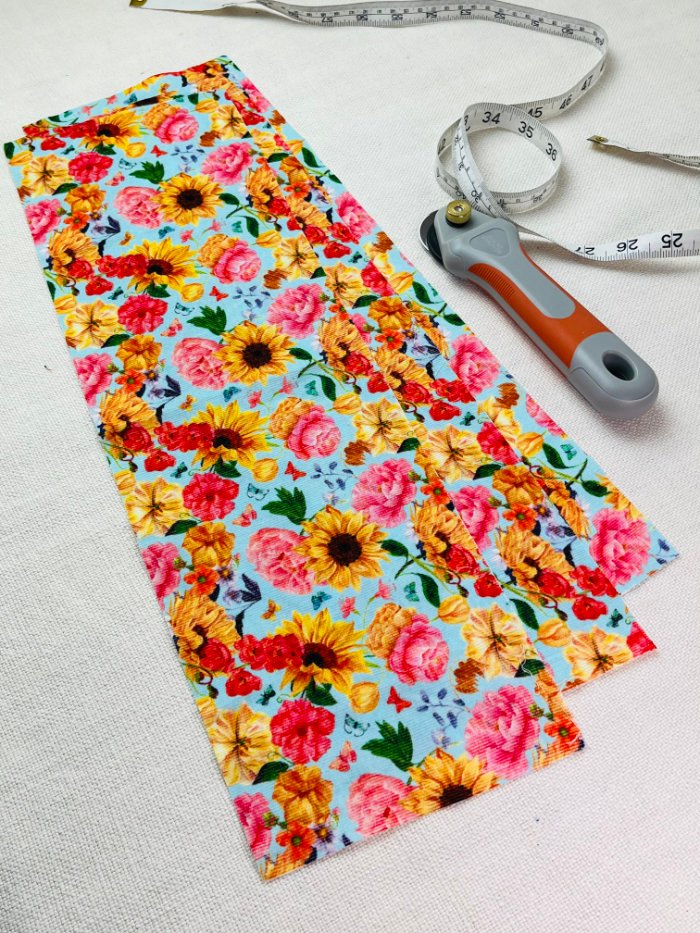 How to Sew a Hair Scrunchie: 4 Easy Methods Using Less Fabric (Beginner-Friendly) A strip of fabric cut in equal length for three scrunchies