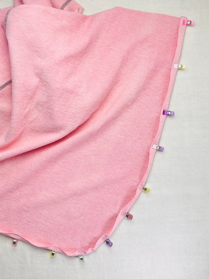 How to Sew a Wrap Skirt from an A-Line Skirt Block (Beginner) Folding and pinning raw wrap skirt edge for rolled hem before stitching