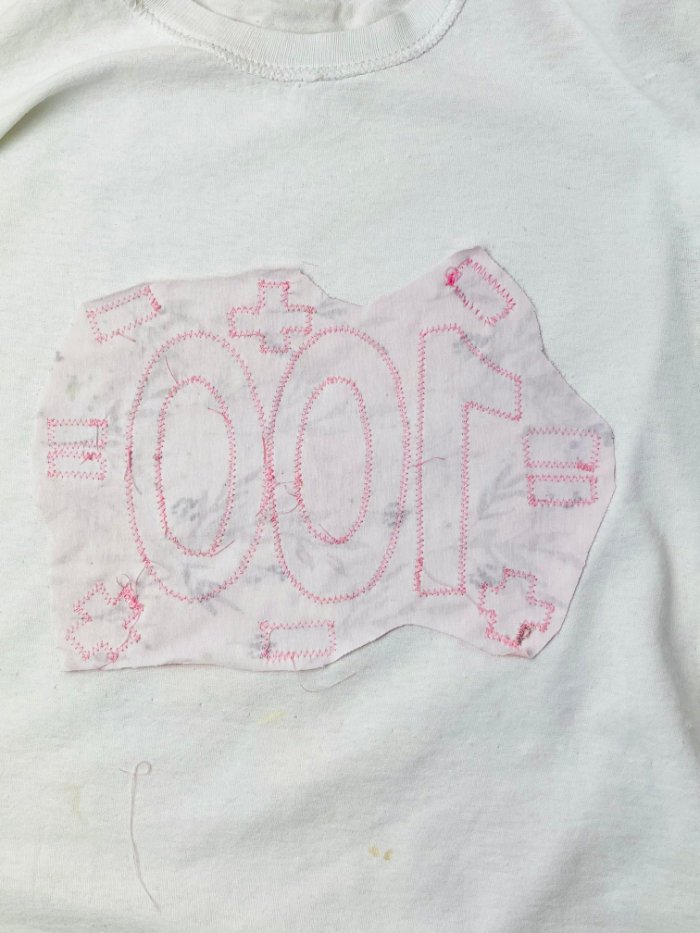 Excess contrast fabric trimmed on the inside of the T-shirt after reverse appliqué