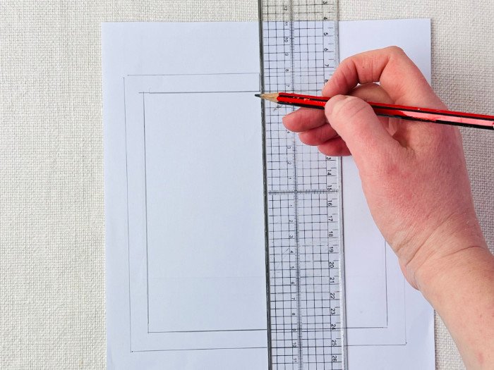 Transferring pattern notches from seam line to seam allowance using a grading ruler on a straight line