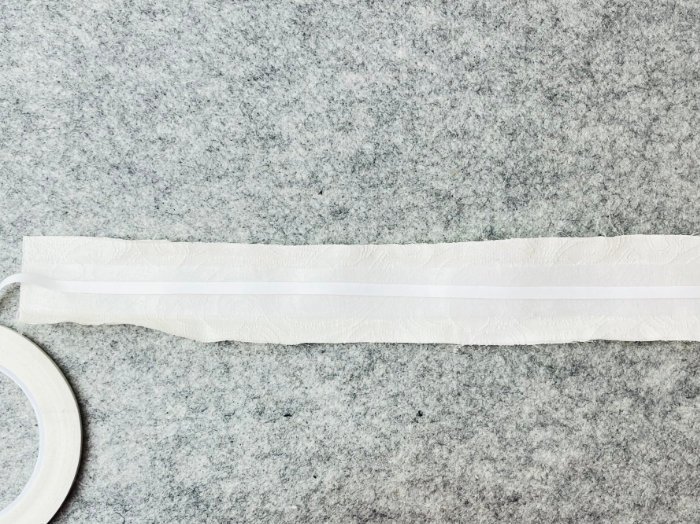 Applying the double sided tape to the centre of the strap